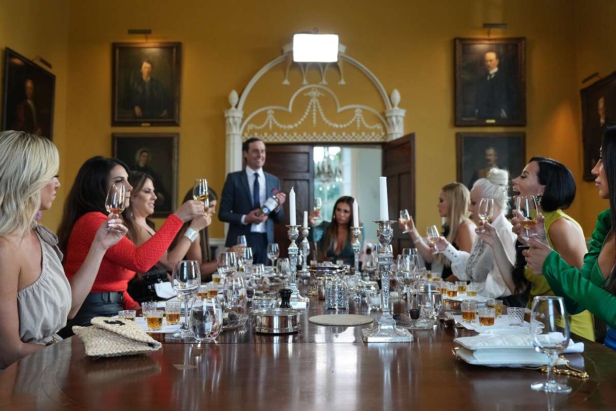 Danielle Cabral, Jennifer Aydin, Jennifer Fessler, Teresa Giudice, Dolores Catania, Jackie Goldschneider, Margaret Josephs, Rachel Fuda, Melissa Gorga pose at a table together during season 13 of 'The Real Housewives of New Jersey'