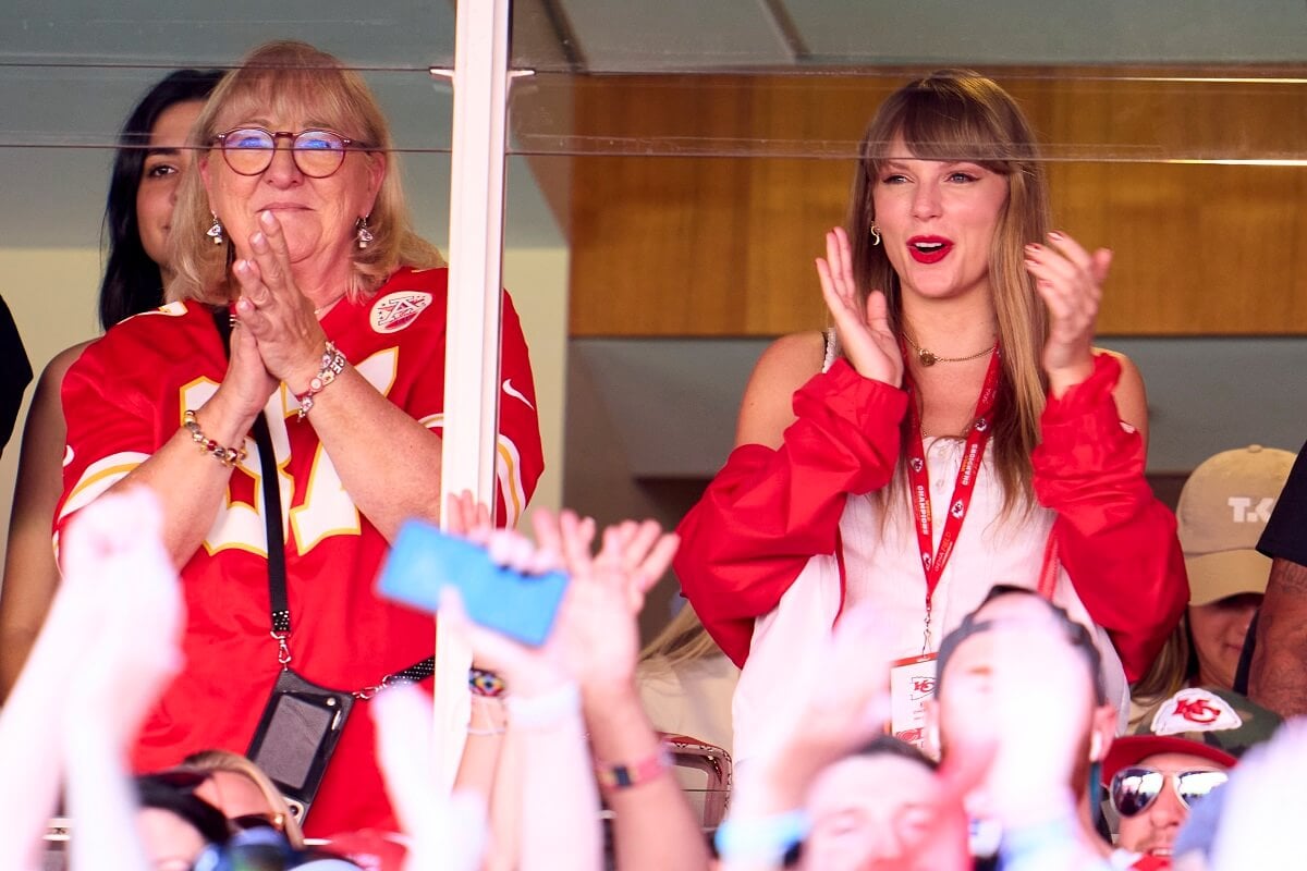 Taylor Swift, who a body language expert says may not be romantically involved with Travis Kelce just yet, cheering him on alongside his mother, Donna Kelce, from a suite