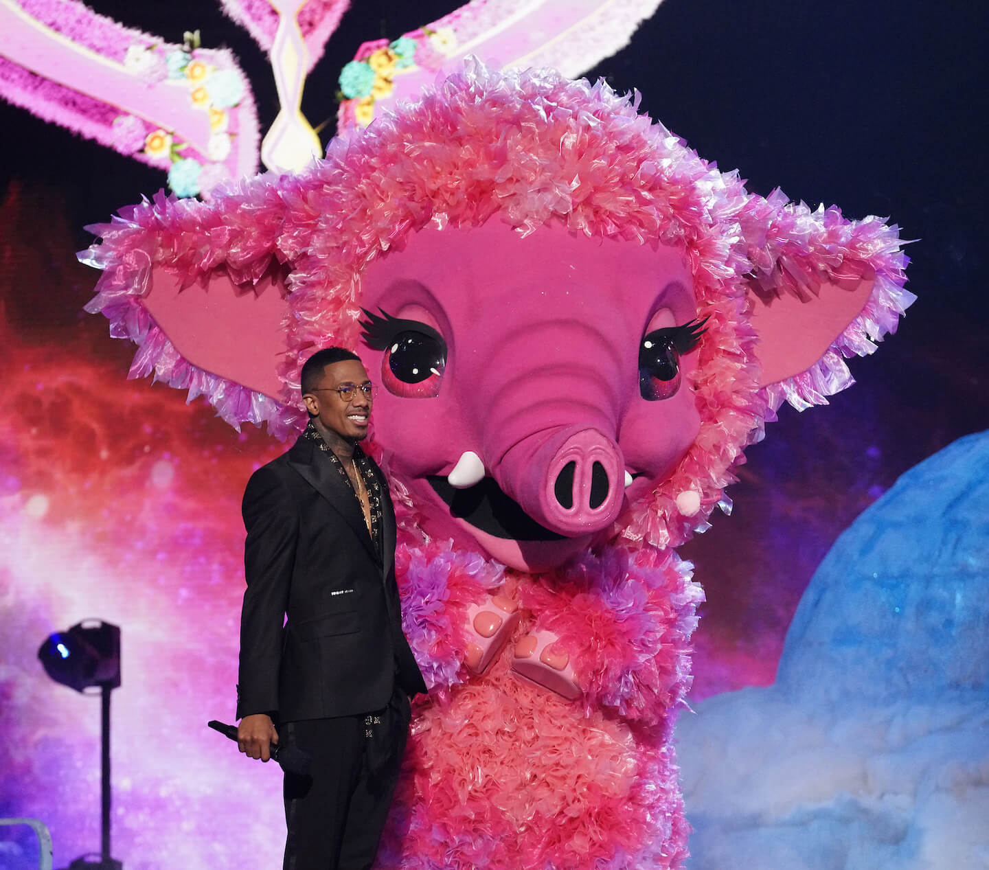 'The Masked Singer' host Nick Cannon next to the Baby Mammoth costume
