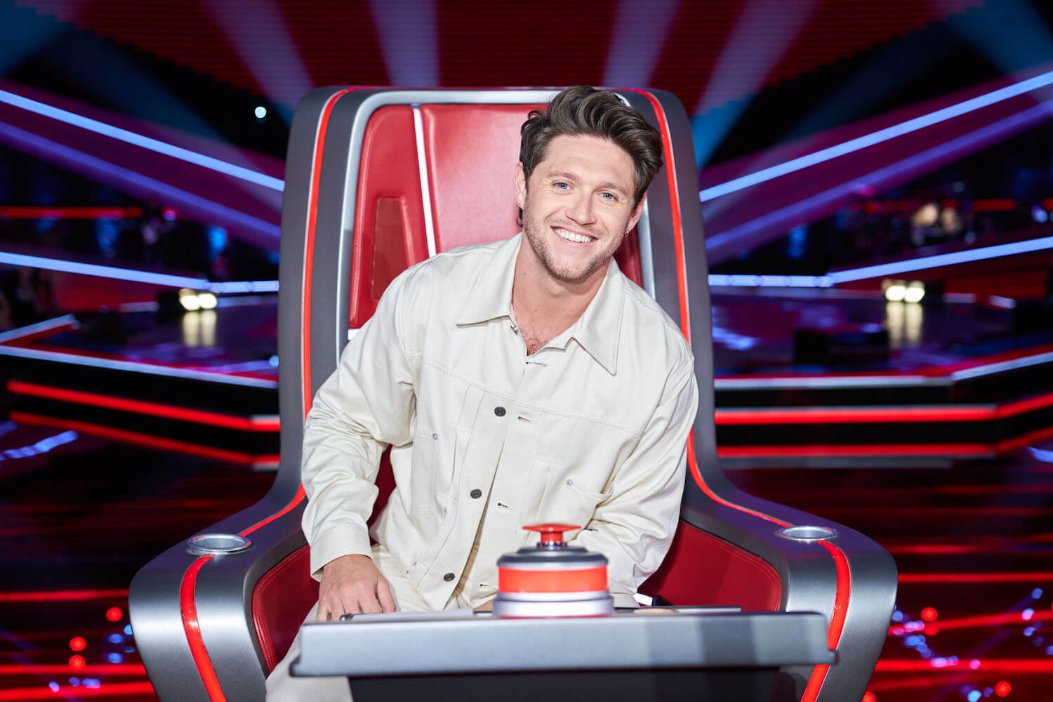 'The Voice' Season 24 judge Niall Horan sitting in the judge's chair and smiling