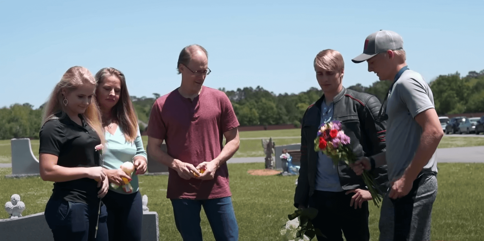 The Plath family gathering around Joshua Plath's grave in 'Welcome to Plathville.' Joshua Plath died at 15 months old