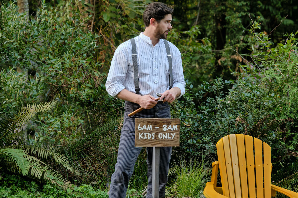 Lucas standing behind a "kids only" sign in 'When Calls the Heart' Season 10