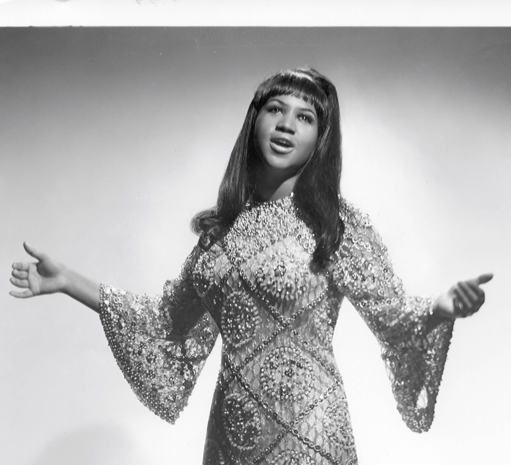 Aretha Franklin raising her arms