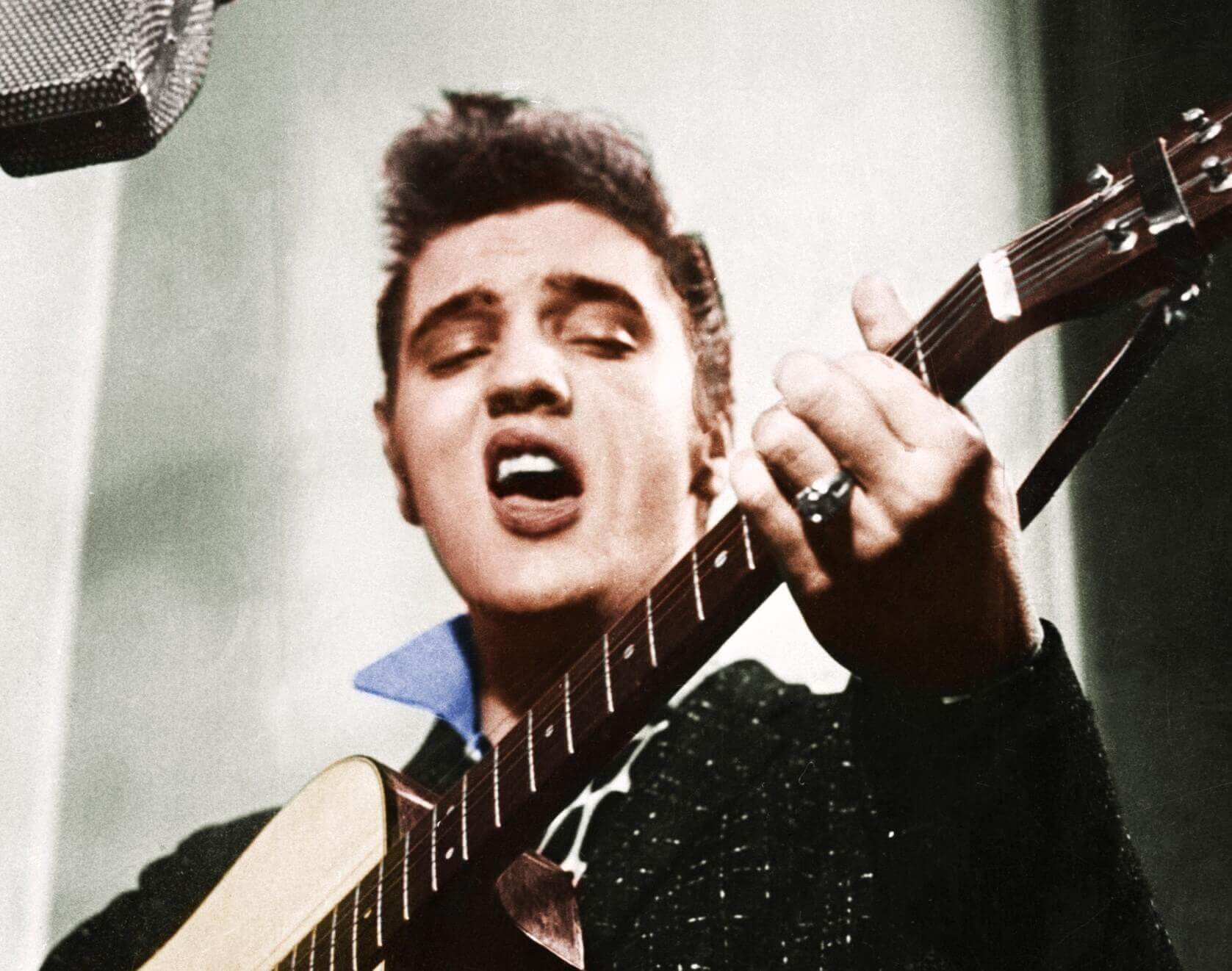 "Blue Suede Shoes" singer Elvis Presley with a guitar