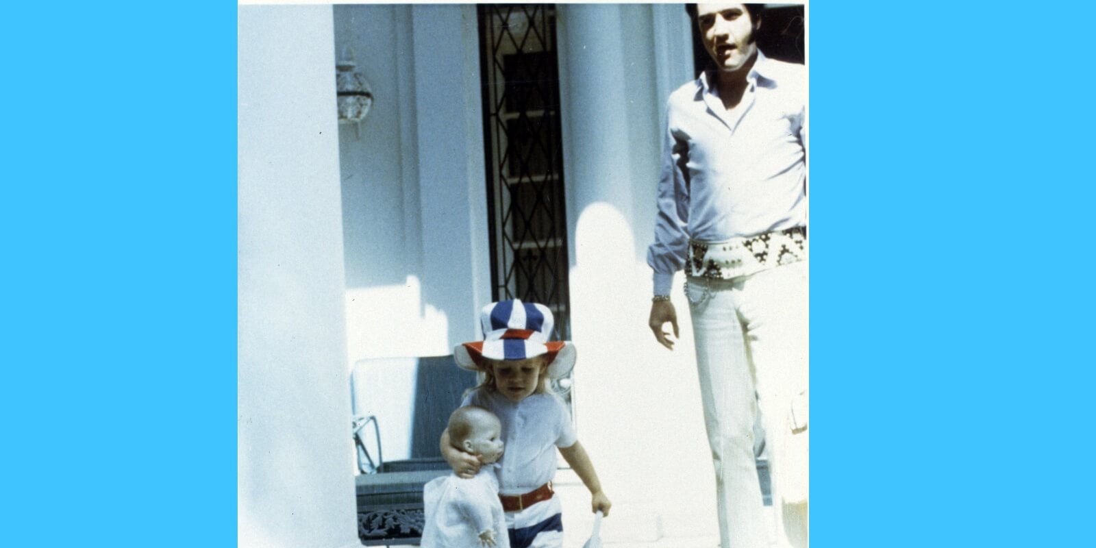 Elvis Presley and Lisa Marie Presley pose outside of Graceland in the early 1970s.