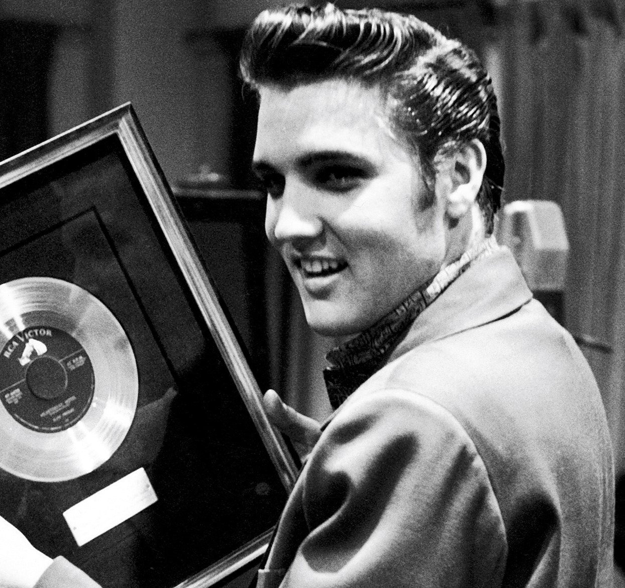 Elvis Presley holding a record
