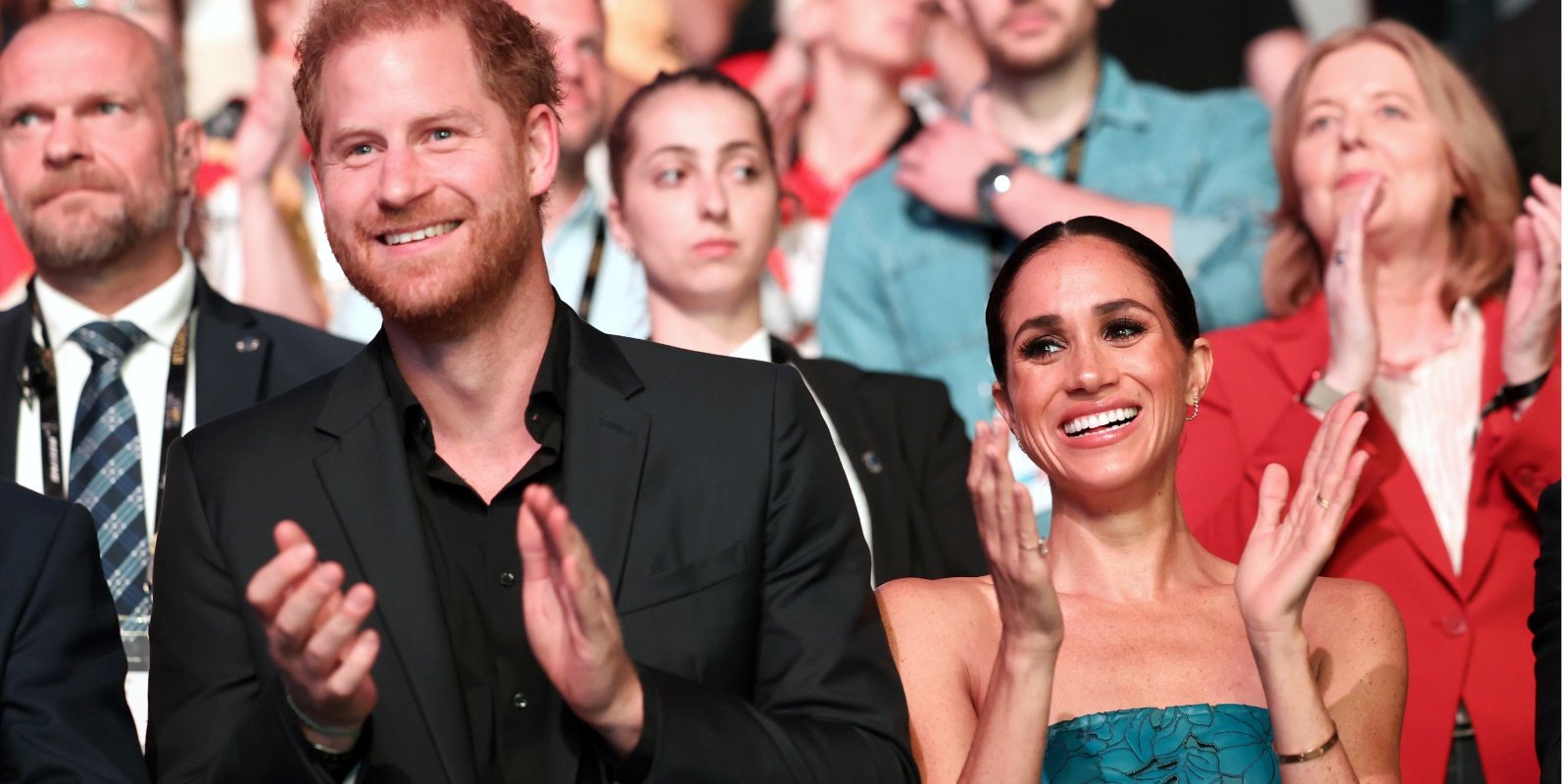 Prince Harry and Meghan Markle clapping at the 2023 Invictus Games in Germany.