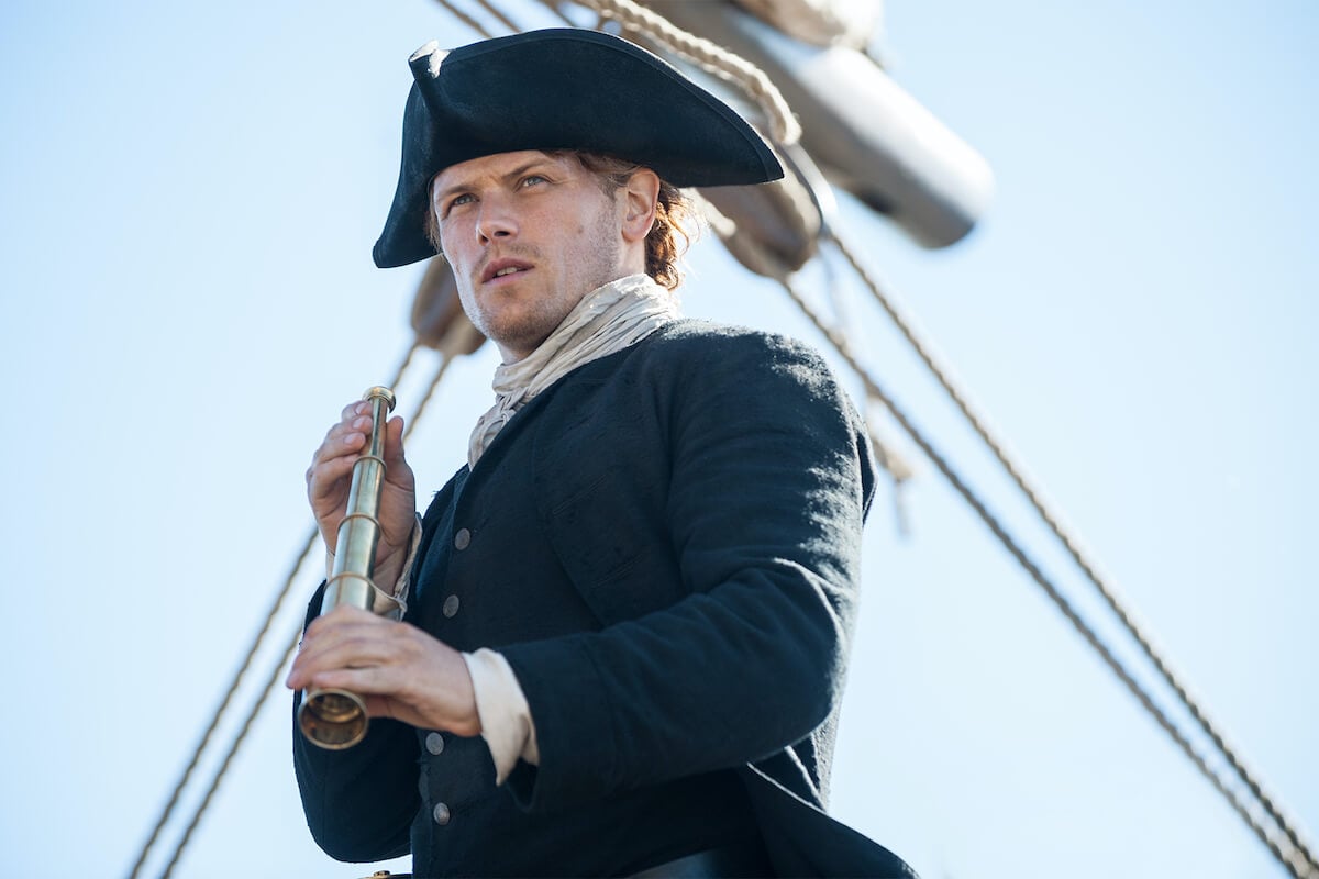 Jamie holding a spyglass and wearing a tricorn hat in 'Outlander'