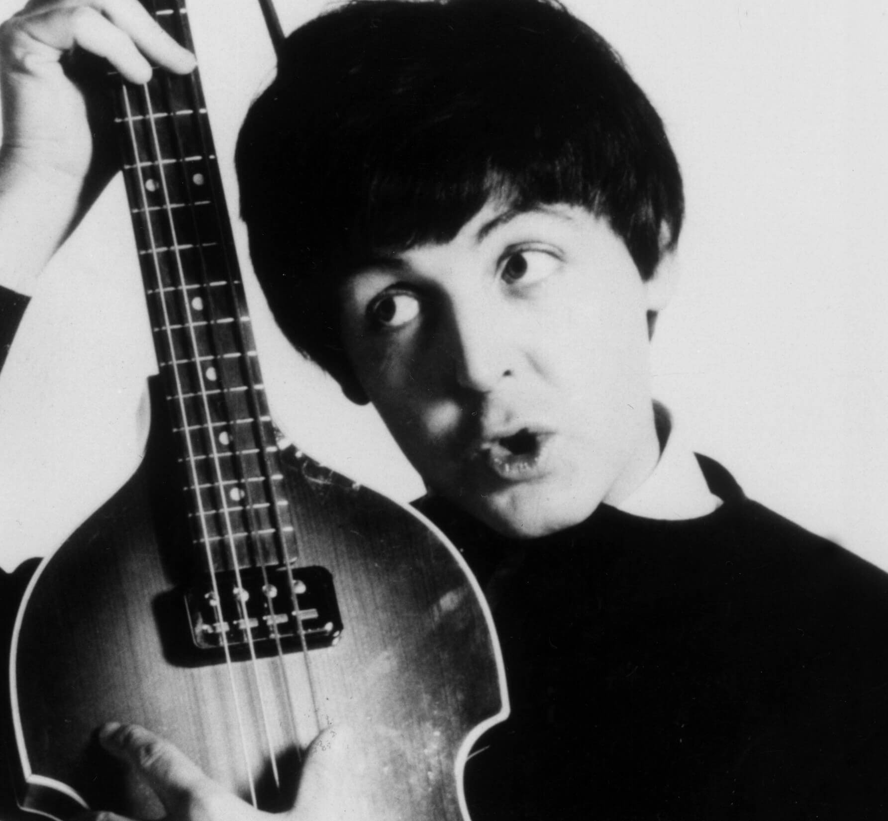 The Beatles' Paul McCartney holding an instrument