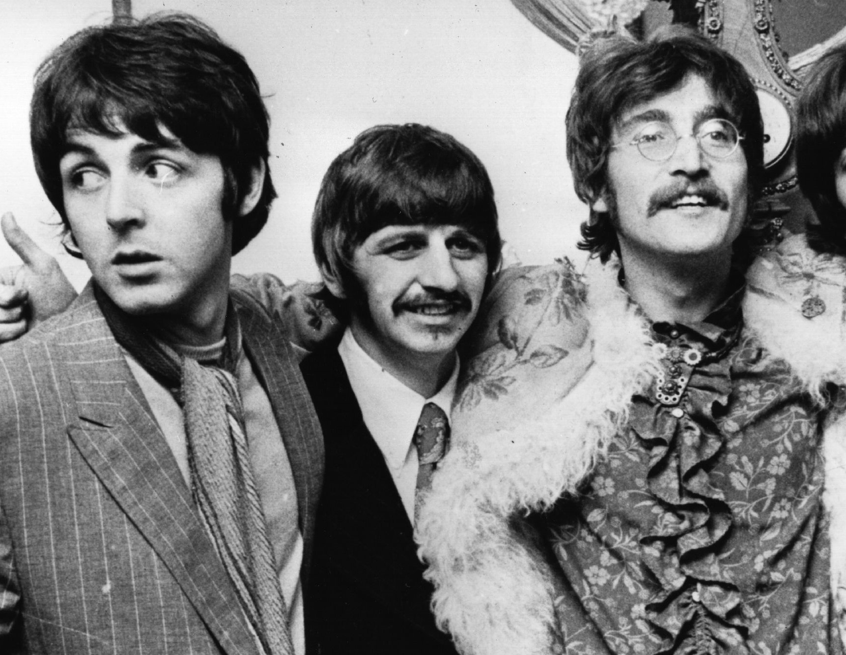 The Beatles' Paul McCartney, Ringo Starr, and John Lennon in black-and-white
