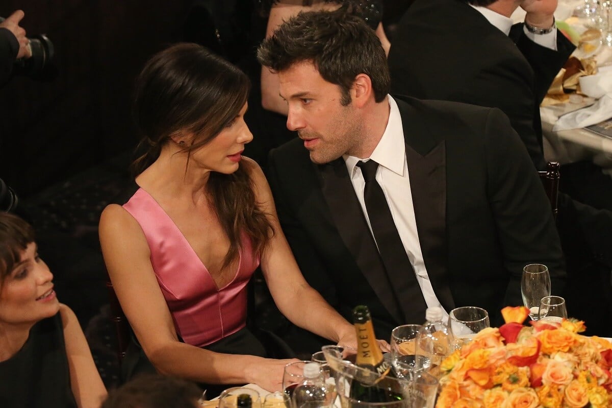 Ben Affleck sitting alongside Sandra Bullock at the Golden Globe Awards.