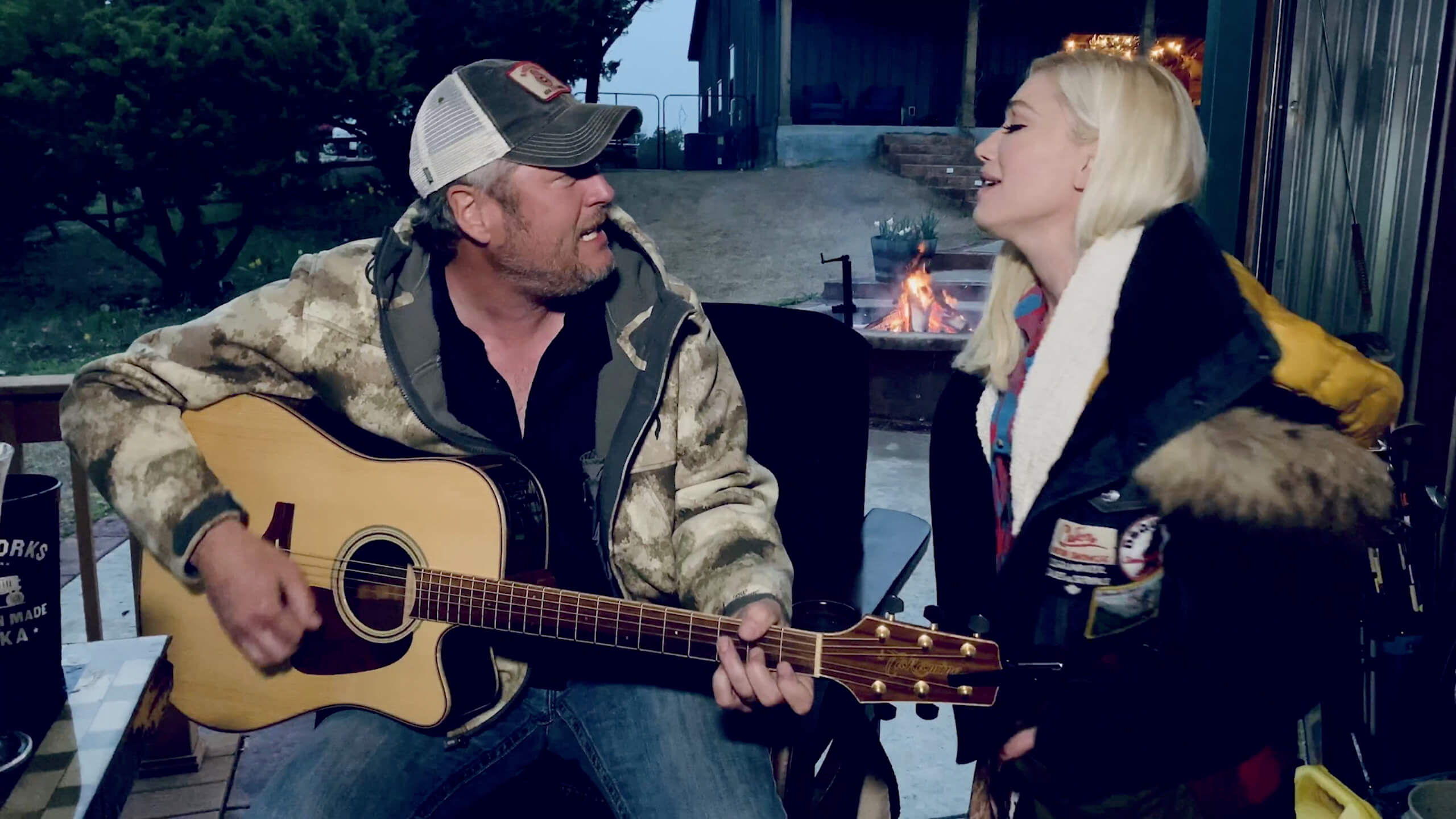 Blake Shelton and Gwen Stefani singing together outside of their Oklahoma country ranch