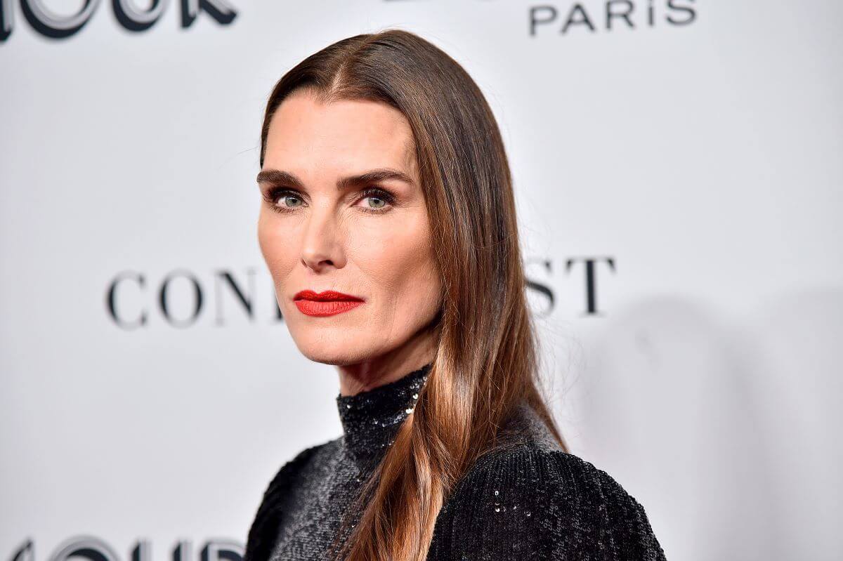 Brooke Shields wears a black sequined dress and red lipstick.