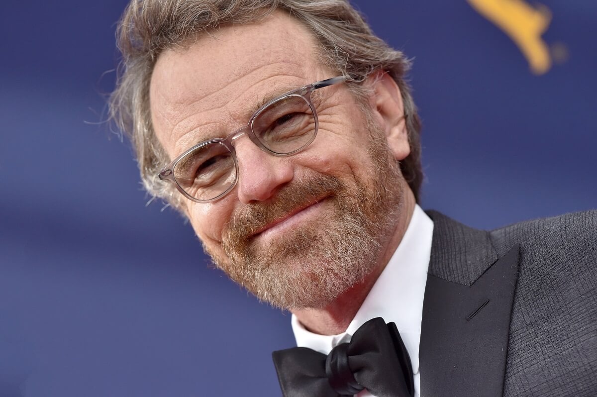 Bryan Cranston posing in a suit at the 2018 Creative Arts Emmy Awards.