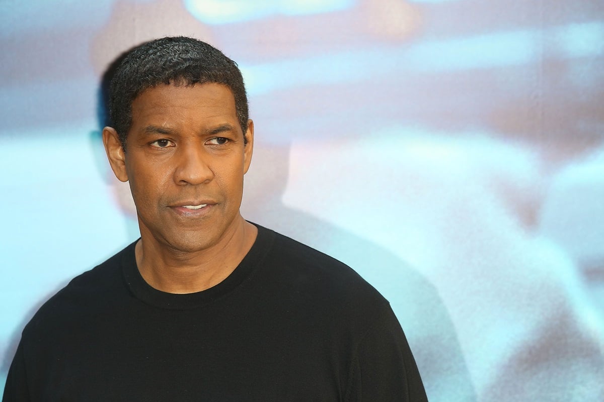 Denzel Washington posing at the premiere of 'The Equalizer' in a black shirt.