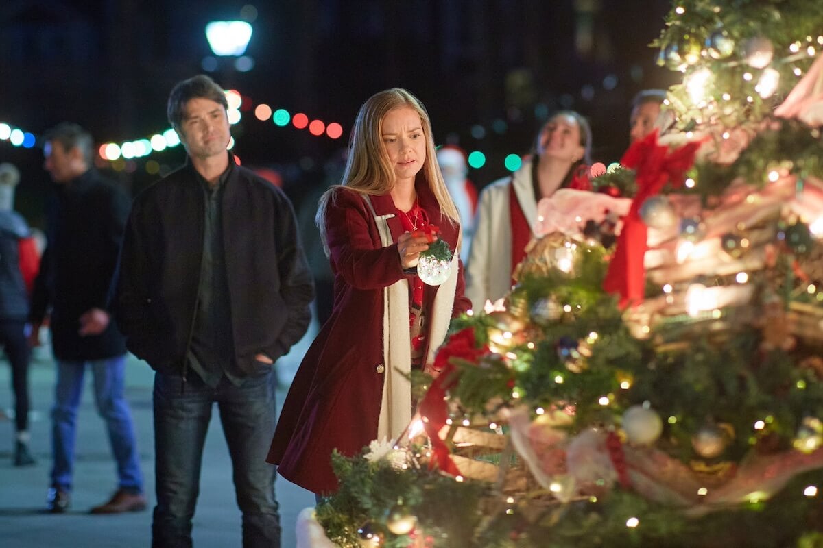 Cindy Busby decorating a Christmas tree in the Hallmark Christmas movie 'Everything Christmas'