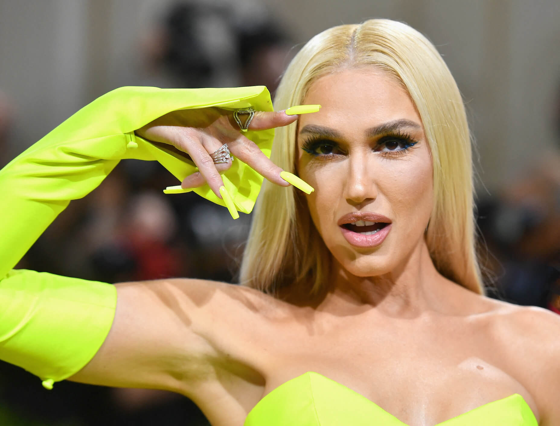 'The Voice' Season 24 coach Gwen Stefani wearing a neon yellow gown and gloves at the Met Gala in 2022