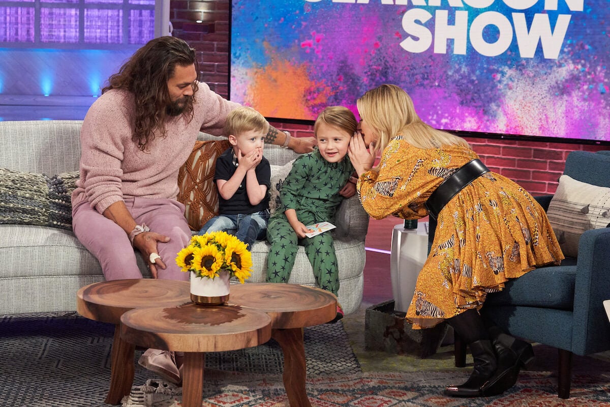 Jason Momoa, Remington Blackstock, River Blackstock, and Kelly Clarkson sit on a couch