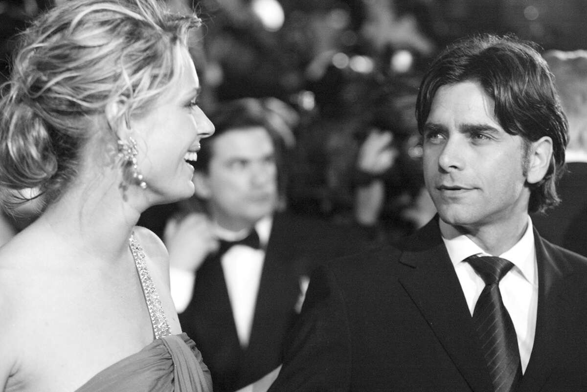 Rebecca Romijn and John Stamos during 2004 Vanity Fair Oscar Party shortly before their marriage ended