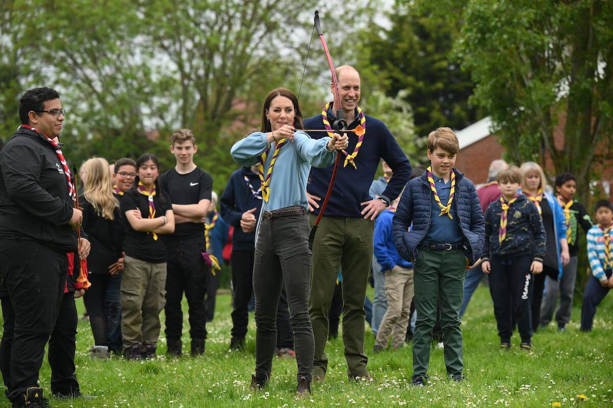 Kate Middleton, who lost an argument over Prince George going to Eton boarding school, stands with Prince William and Prince George