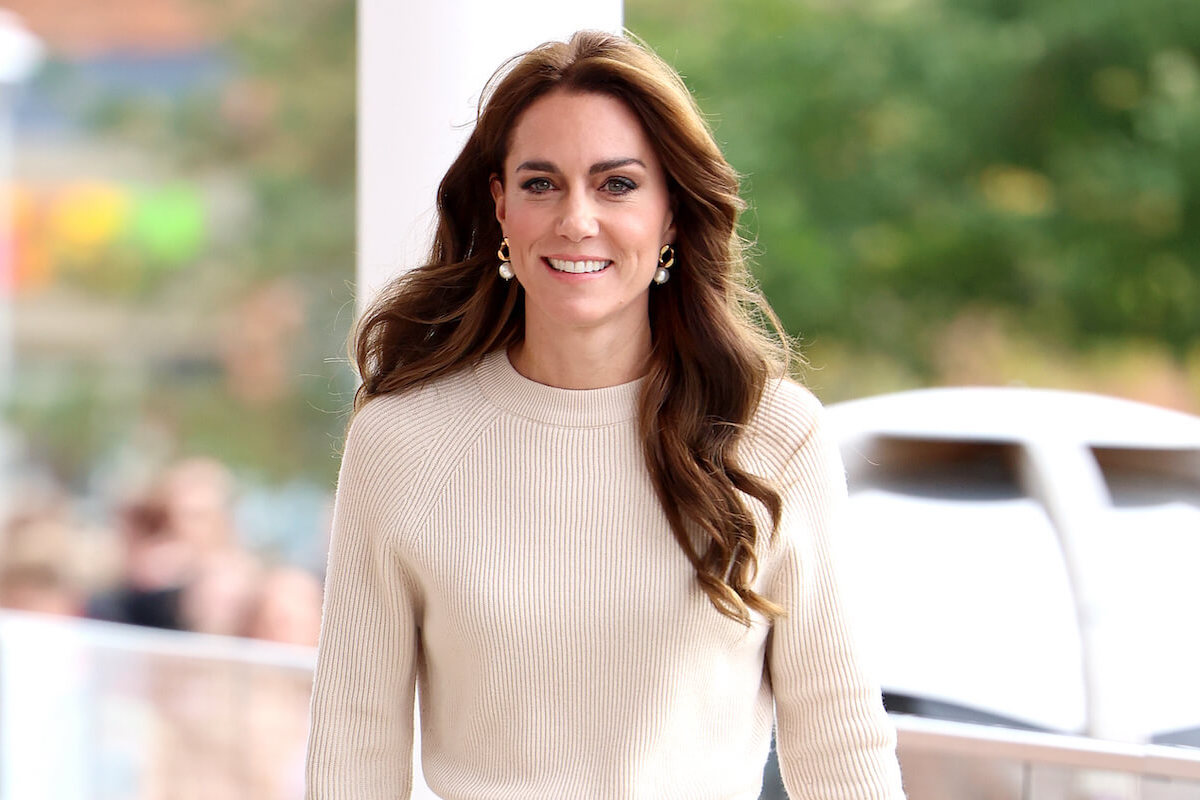 Kate Middleton, whose position in the royal family as Princess of Wales is likely 'lonely,' smiles