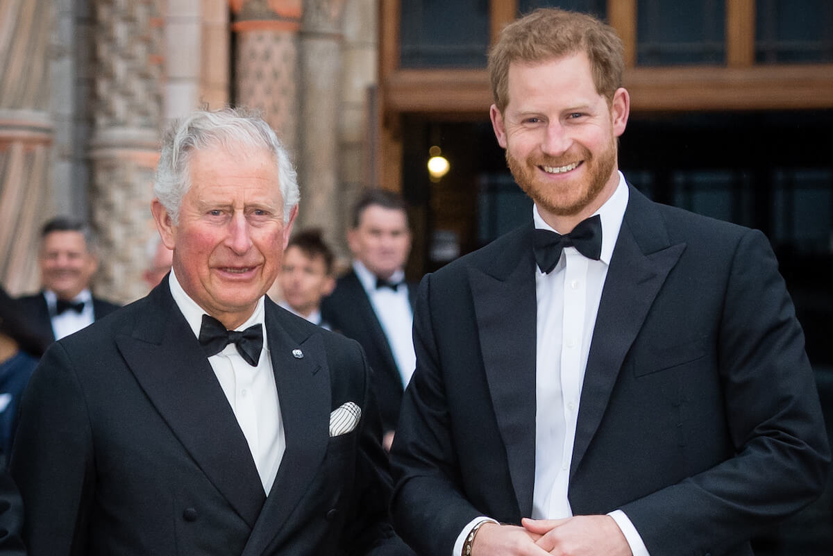 King Charles III and Prince Harry, who is a Counselor of State and required to have a U.K. home, smile