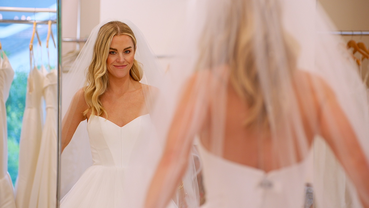 Stacy from 'Love Is Blind' wearing a wedding dress and looking in a mirror