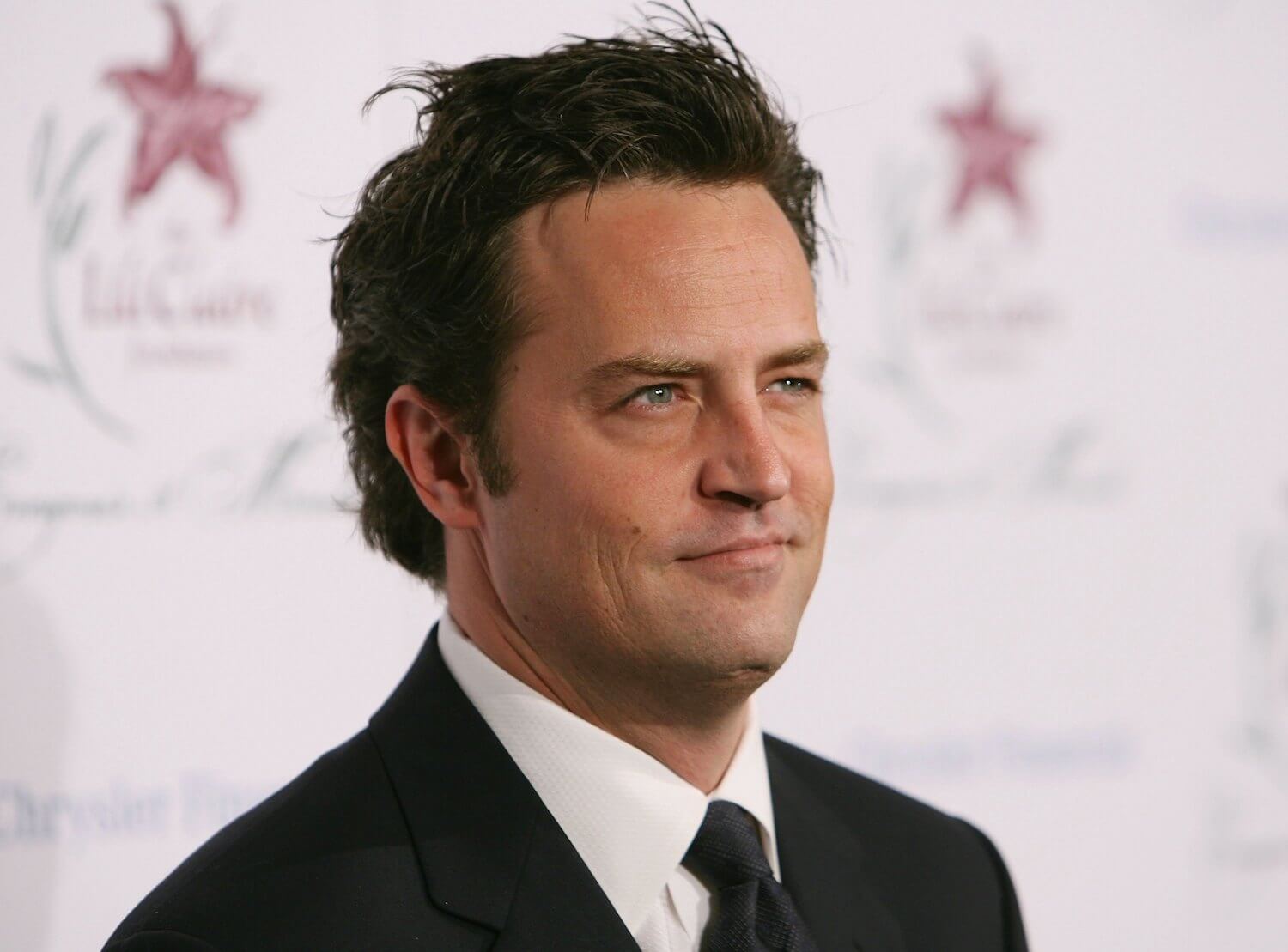 Matthew Perry in a suit at an event