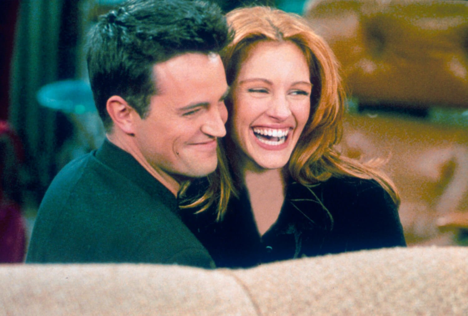 Matthew Perry and Julia Roberts laughing together on the set of 'Friends'