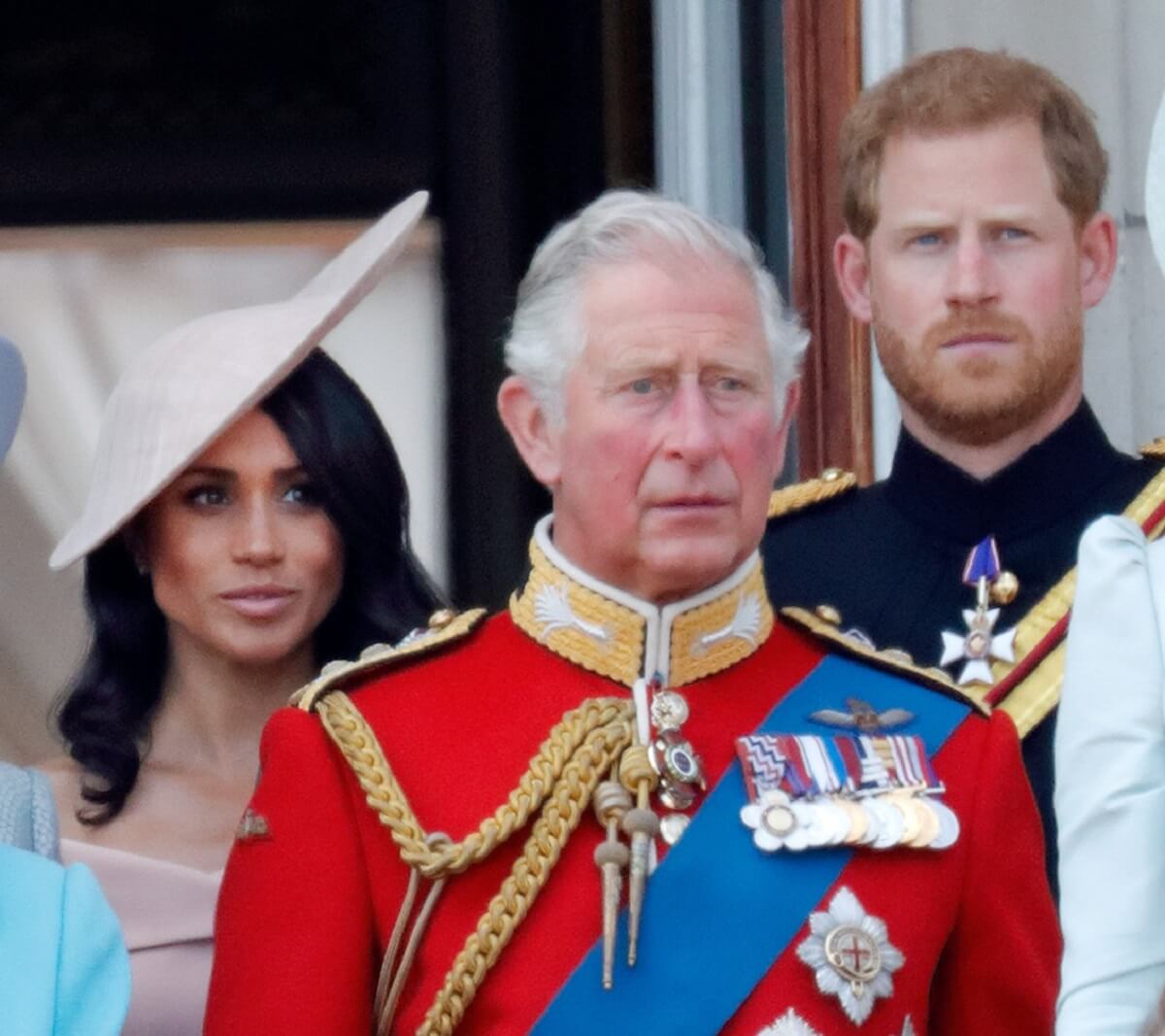 Meghan Markle, King Charles III, and Prince Harry standing on the balcony of Buckingham Palace during Trooping The Colour 2018