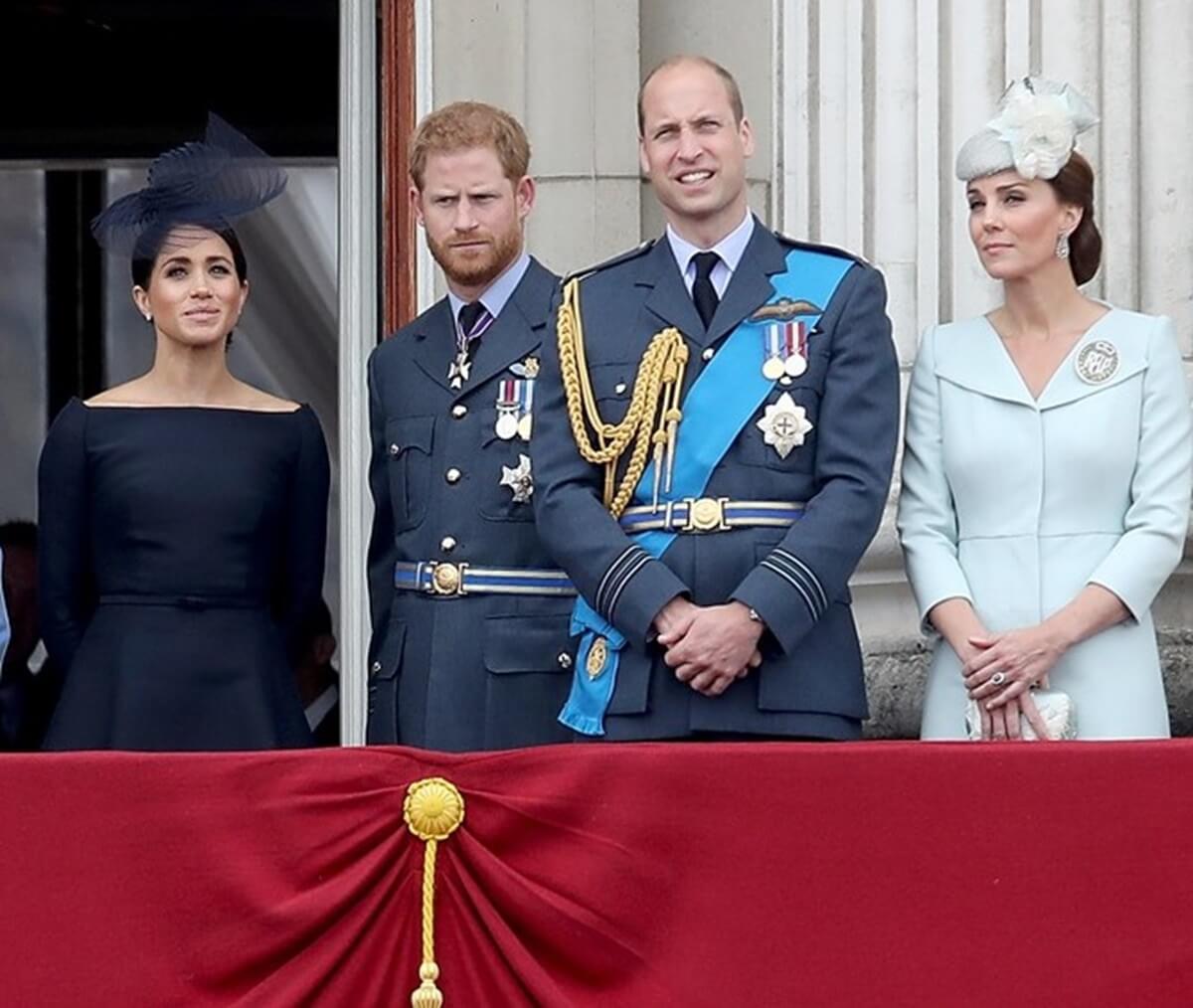Meghan Markle, Prince Harry, Prince William, and Kate Middleton watch the RAF flypast on the balcony of Buckingham Palace