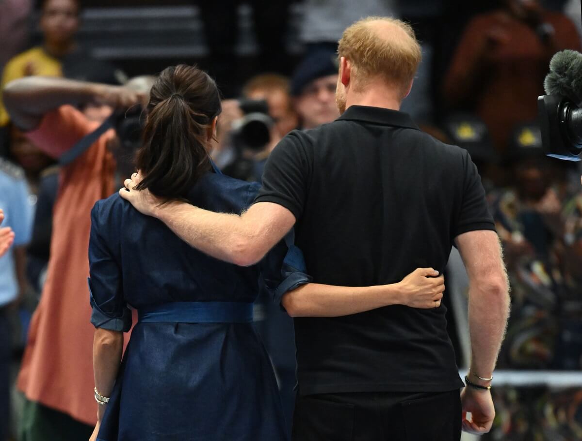 Meghan Markle and Prince Harry walking with their arms around each other during day six of the Invictus Games Düsseldorf 2023