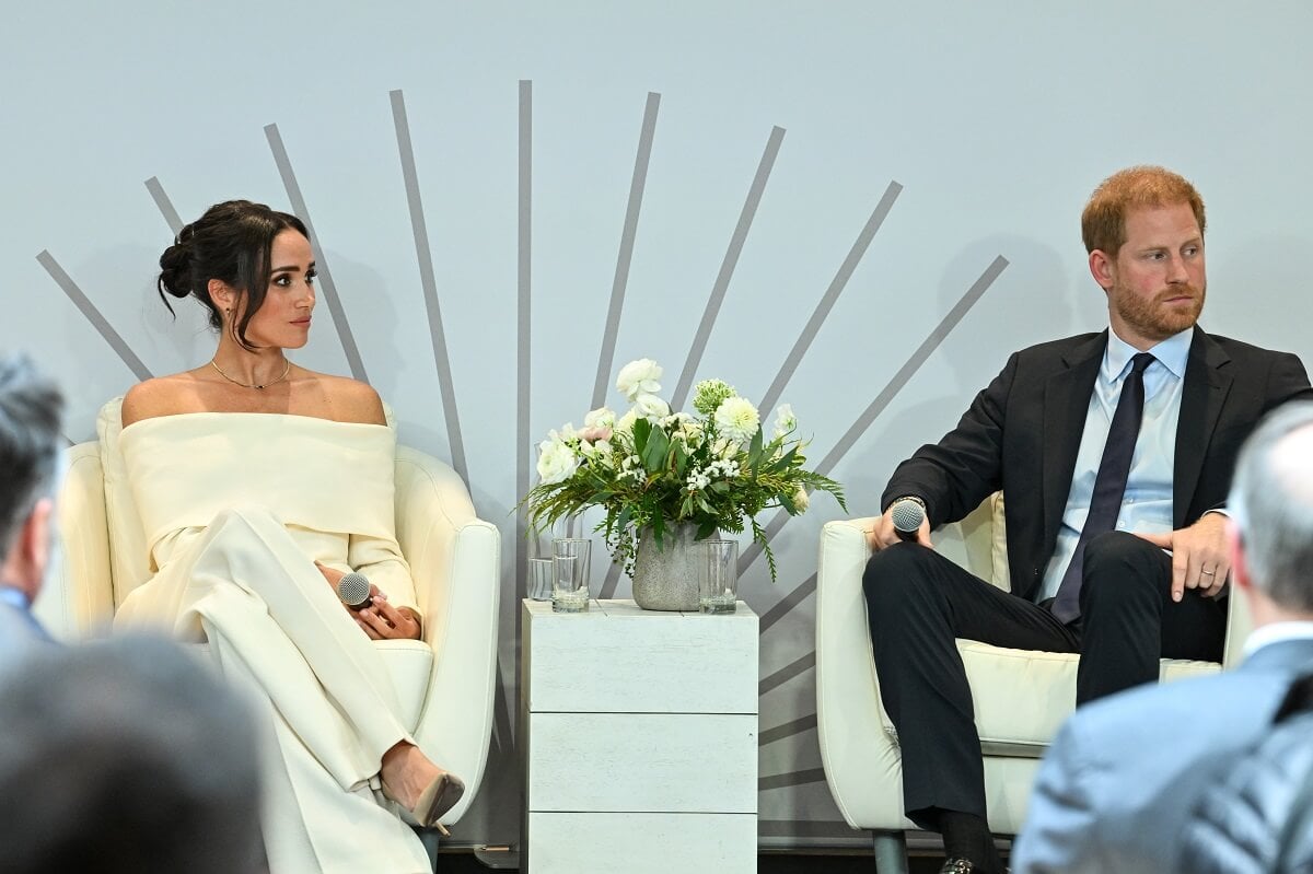 Meghan Markle and Prince Harry, who a body language expert says was 'frustrated' sharing airtime, onstage during Project Healthy Minds' World Mental Health Day in New York City