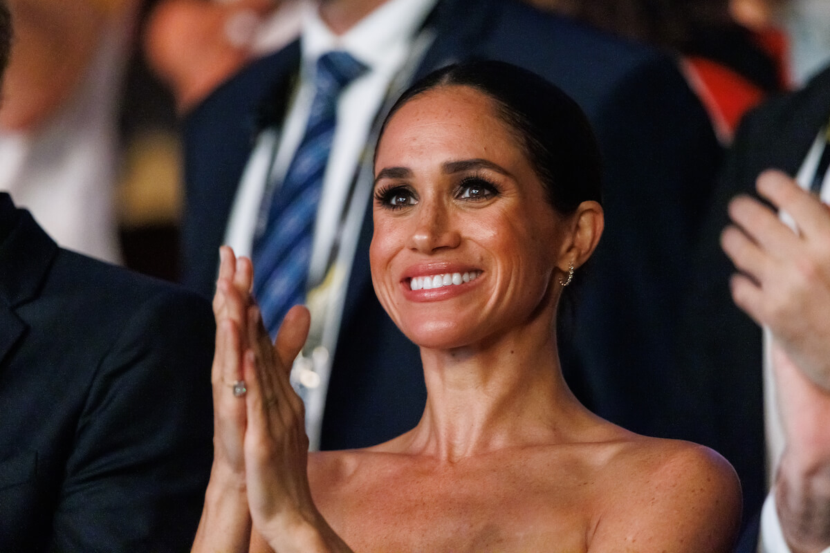 Meghan Markle, who has 'moved on' from royal family life, per a biographer, claps