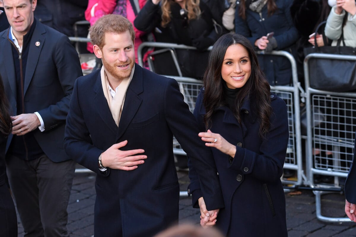 Meghan Markle, who has 'moved on' from royal family life, walks with Prince Harry in 2017