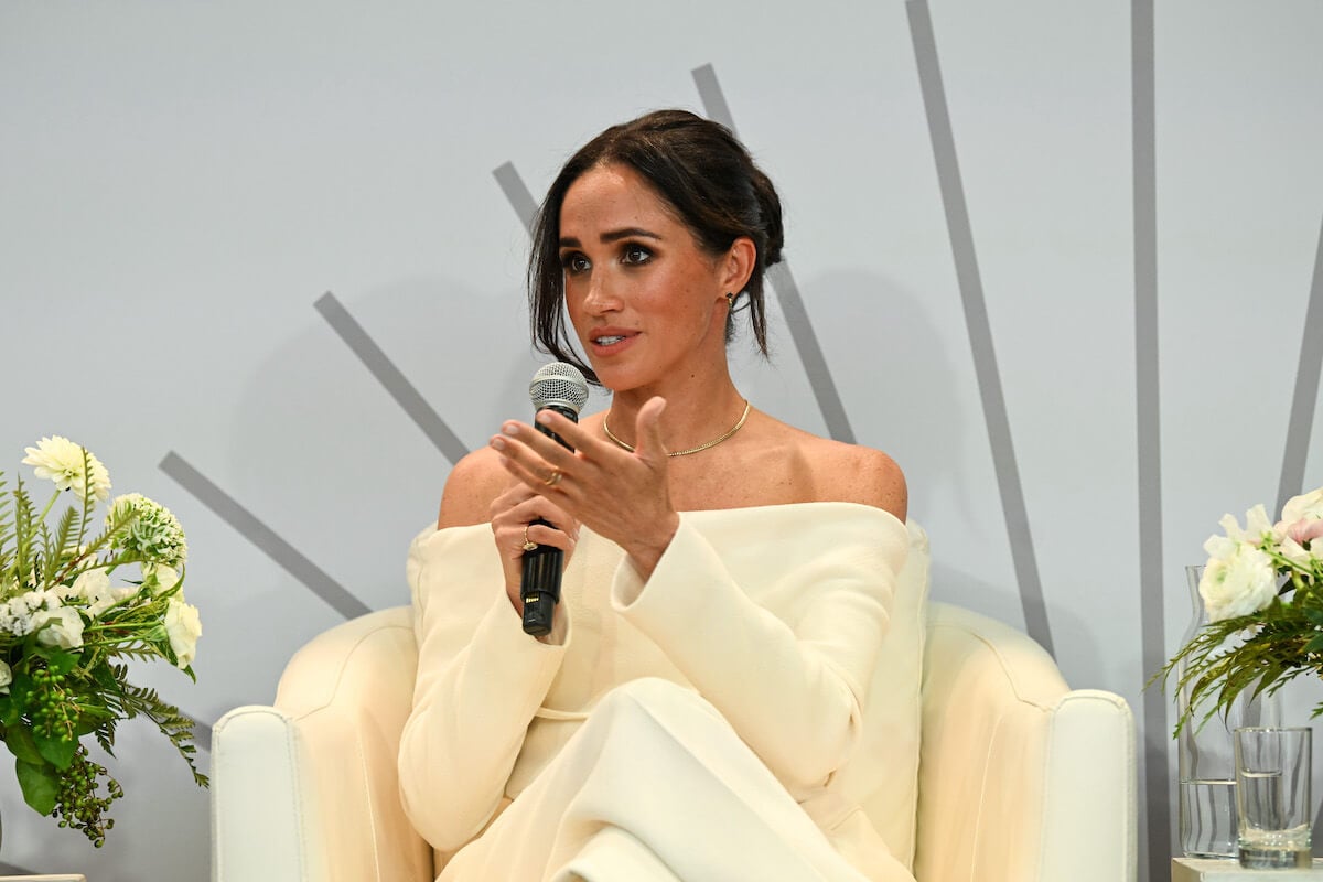 Meghan Markle, who shares children Prince Archie and Princess Lilibet with Prince Harry, speaks into a microphone