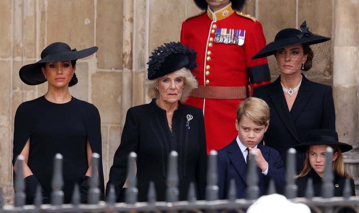 Meghan Markle, who touched Kate Middleton during awkward moment in viral video of Queen Elizabeth's funeral, with Camilla Parker Bowles, Prince George, and Princess Charlotte