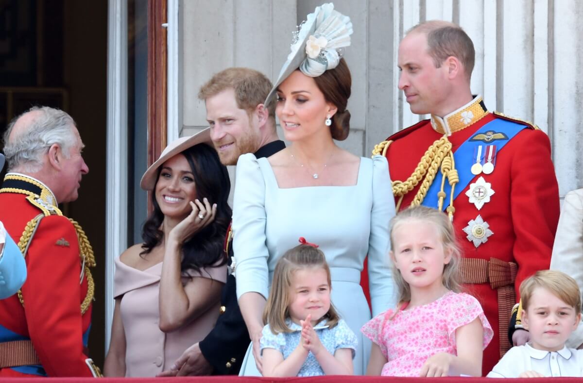 Members of the royal family including Prince Harry and Meghan Markle, who a commentator says the Palace is rewarding by allowing them to keep their titles, during Trooping the Colour