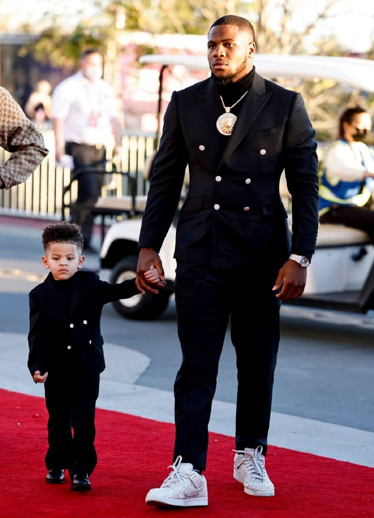Micah Parsons arrives with his son, Malcolm, for the NFL Honors show