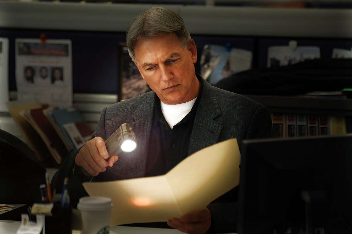 Mark Harmon studies a file on the set of NCIS. While he won the part of Gibbs he wasn't who the network initially had in mind