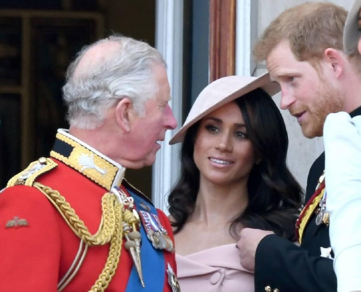 Now-King Charles III, who has a 'sneaky way' of keeping up with Meghan Markle and Prince Harry, standing on the balcony of Buckingham Palace together during Trooping The Colour 2018