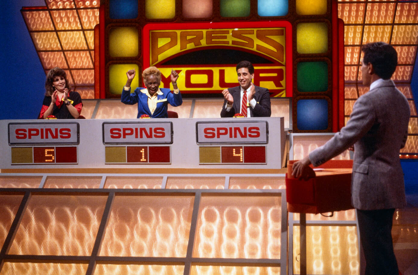 Three contestants on 'Press Your Luck' with Peter Tomarken talking to them as host