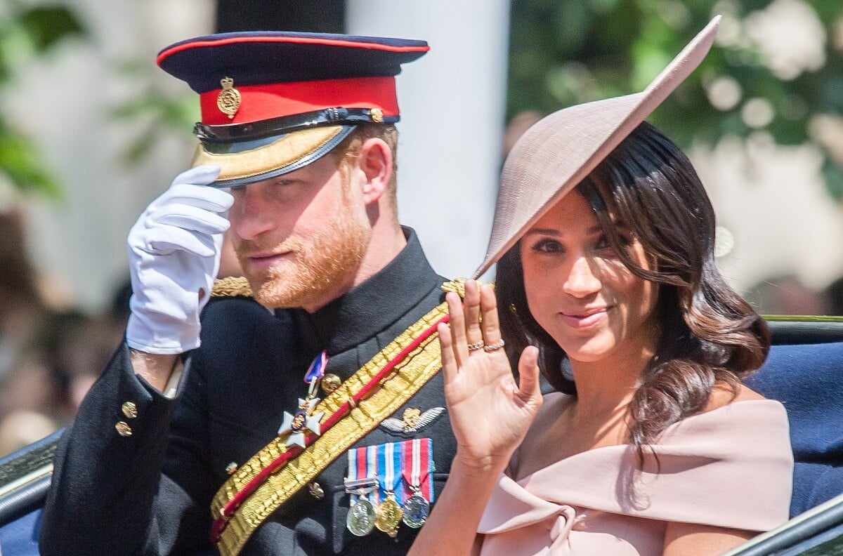 Prince Harry and Meghan Markle riding in a carriage during Trooping The Colour 2018