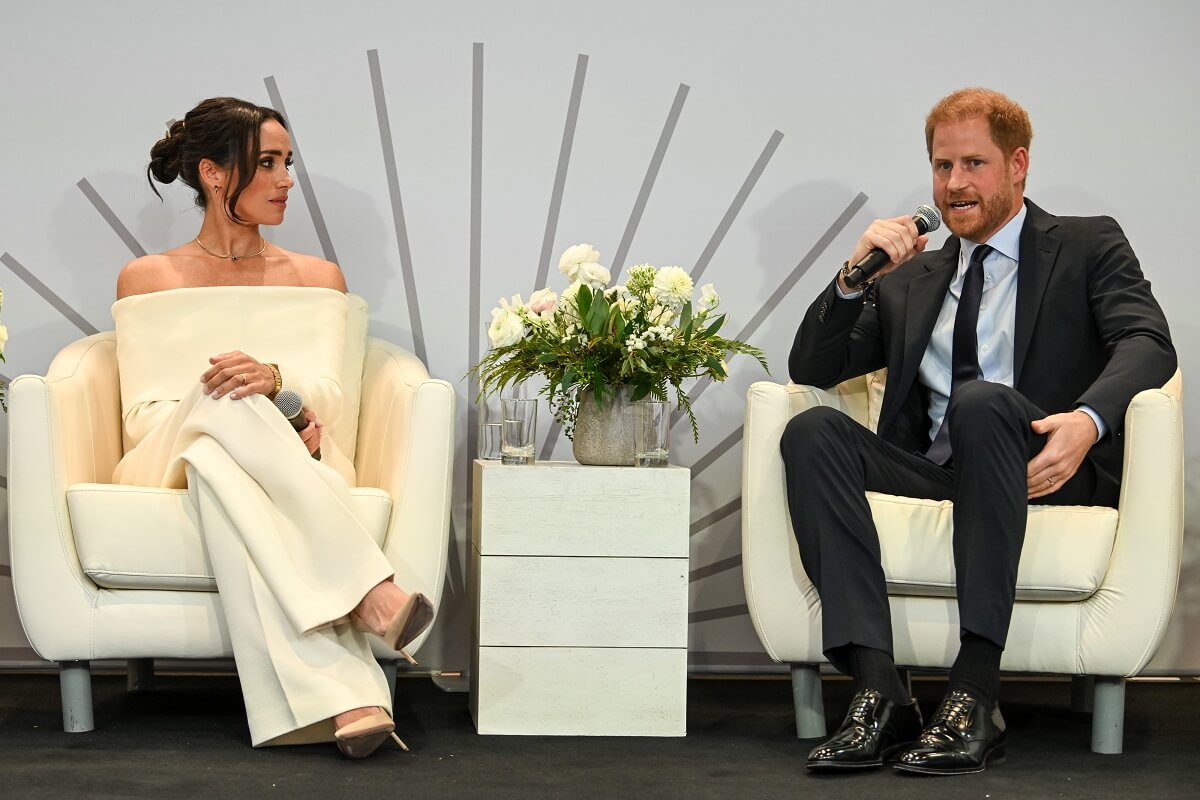 Prince Harry and Meghan Markle, who a body language expert says have 'toned down their affection,' onstage at The Archewell Foundation Parents’ Summit during World Mental Health Day