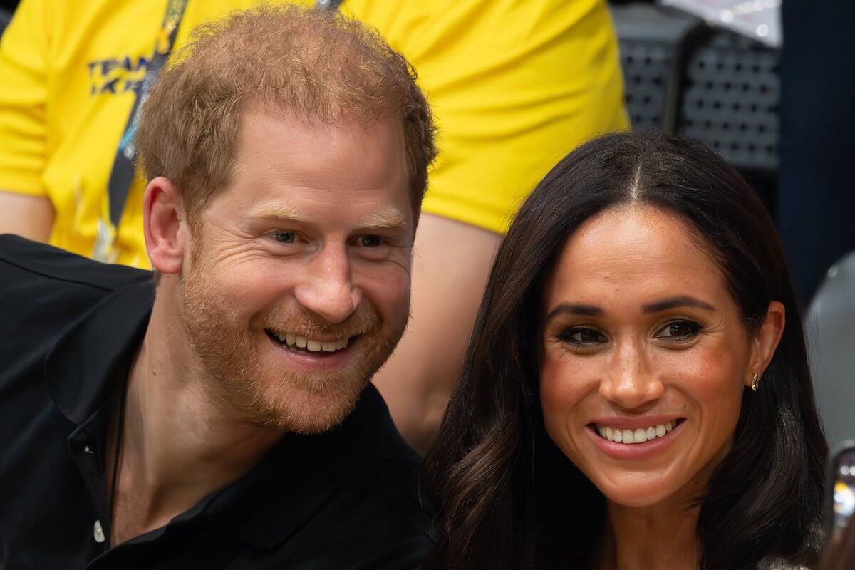 Prince Harry and Meghan Markle, who a historian doesn't believe the U.K. home rumors about, smile