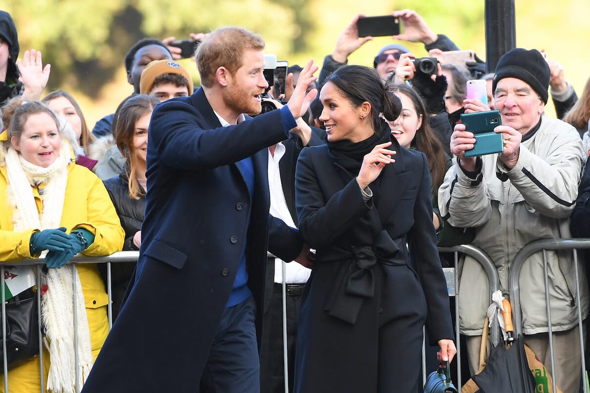 Prince Harry and Meghan Markle, who are rumored to make a possible cameo on 'The Kardashians,' wave to crowds of well-wishers