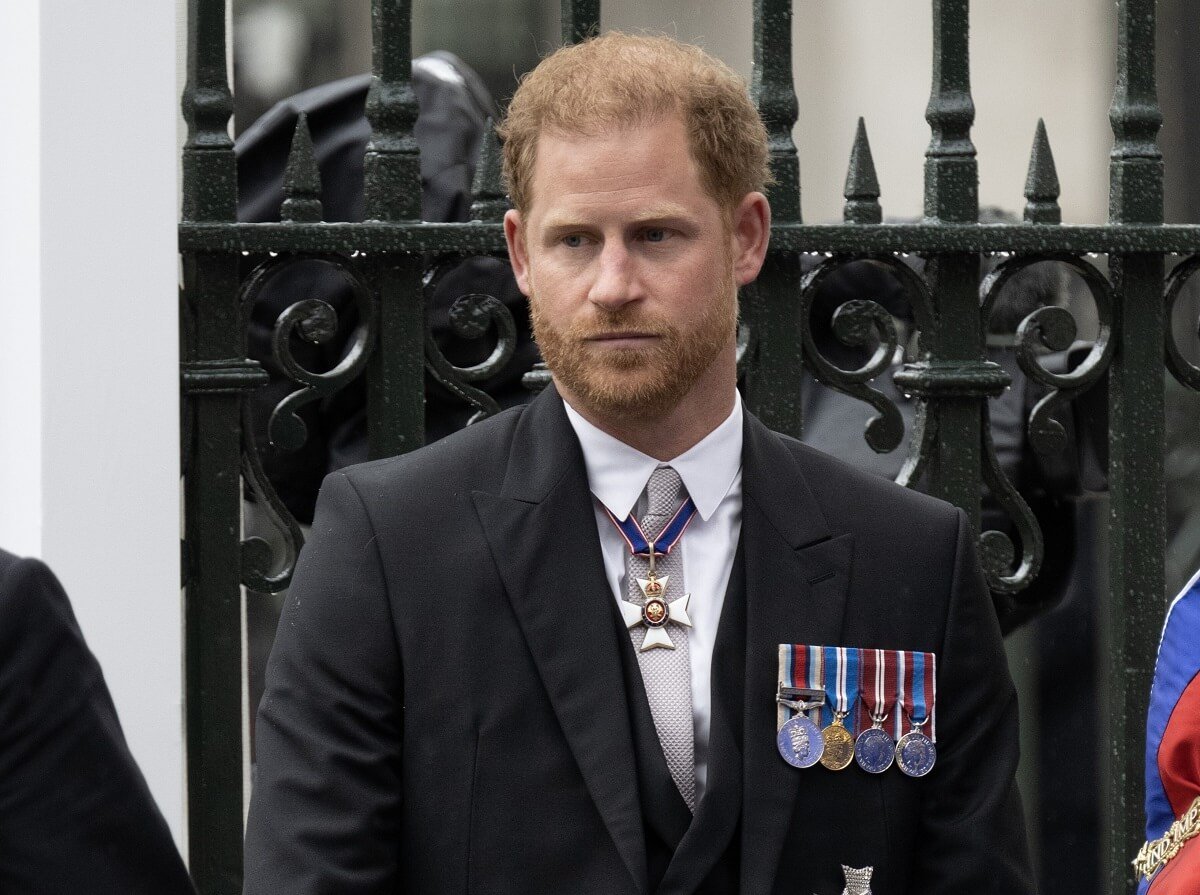 Prince Harry, who a lip reader says told his family he was 'fed up' at King Charles' coronation, arrives for the ceremony in Westminster Abbey