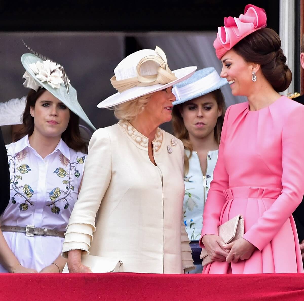 Princess Eugenie, Camilla Parker Bowles, and Kate Middleton standing on the Buckingham Palace balcony
