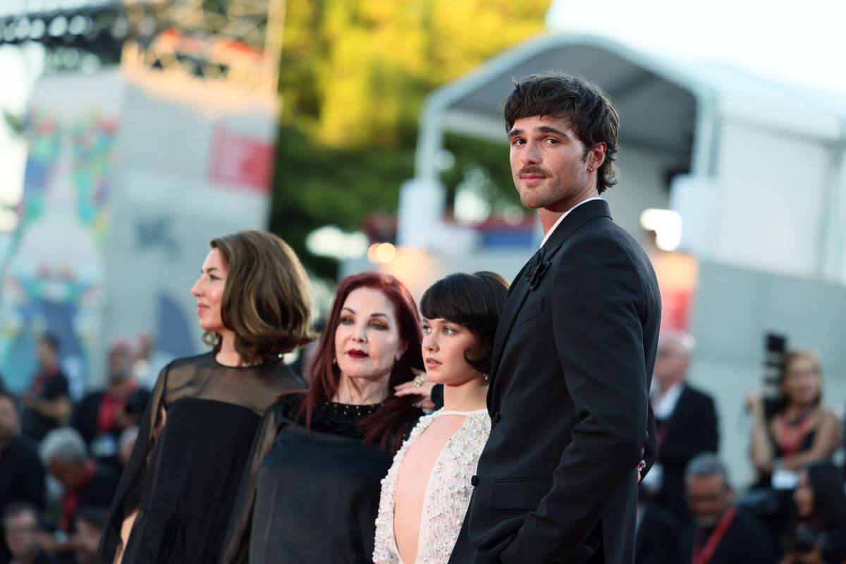 Sofia Coppola, Priscilla Presley, Cailee Spaeny, and Jacob Elordi stand in a line on the red carpet.