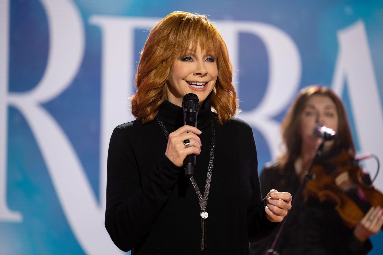 'The Voice' Season 24 coach Reba McEntire talking into a microphone